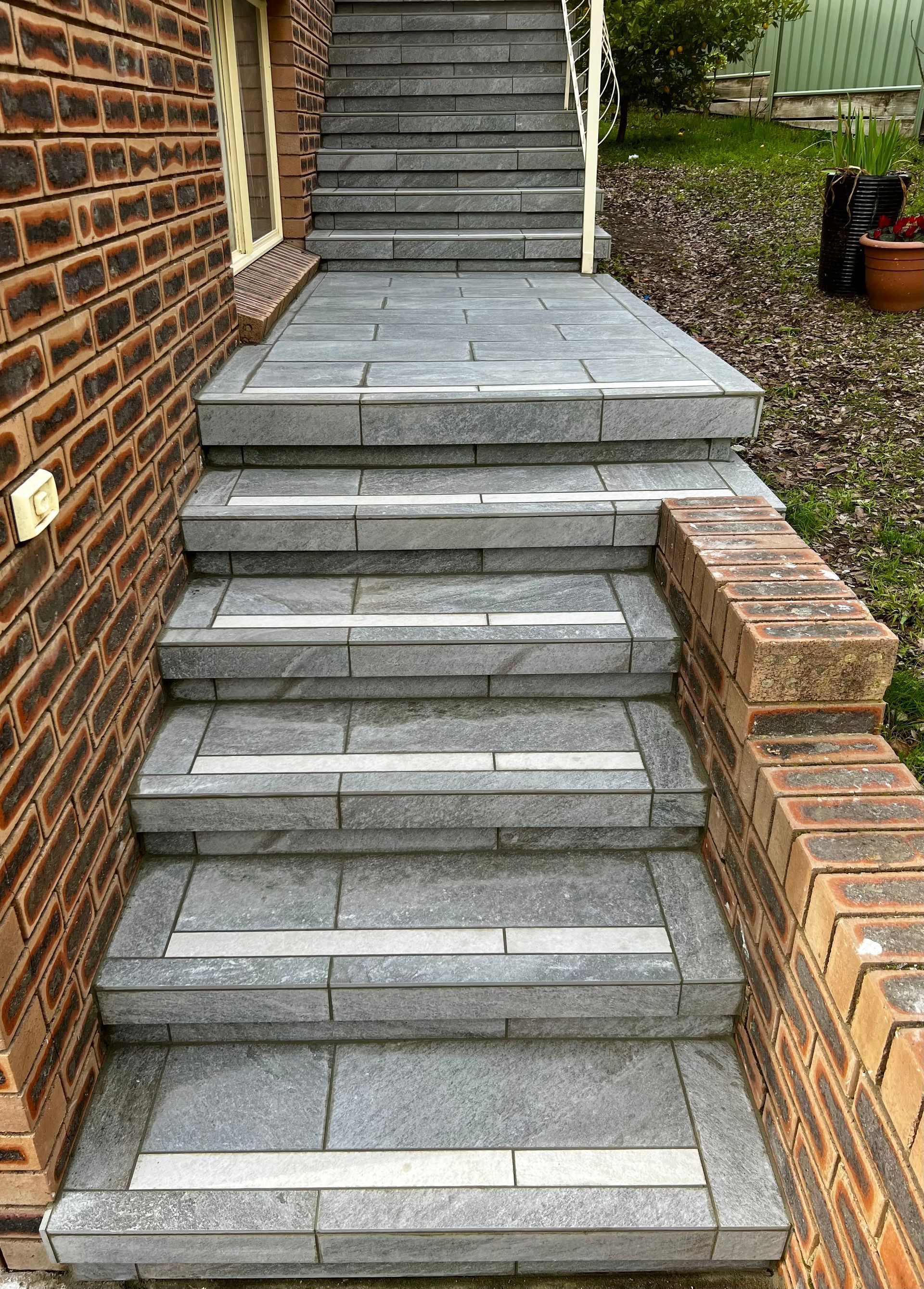 A Set of Stairs Leading up To a Brick Building — P & M Maintenance Building Services in Yass River, NSW
