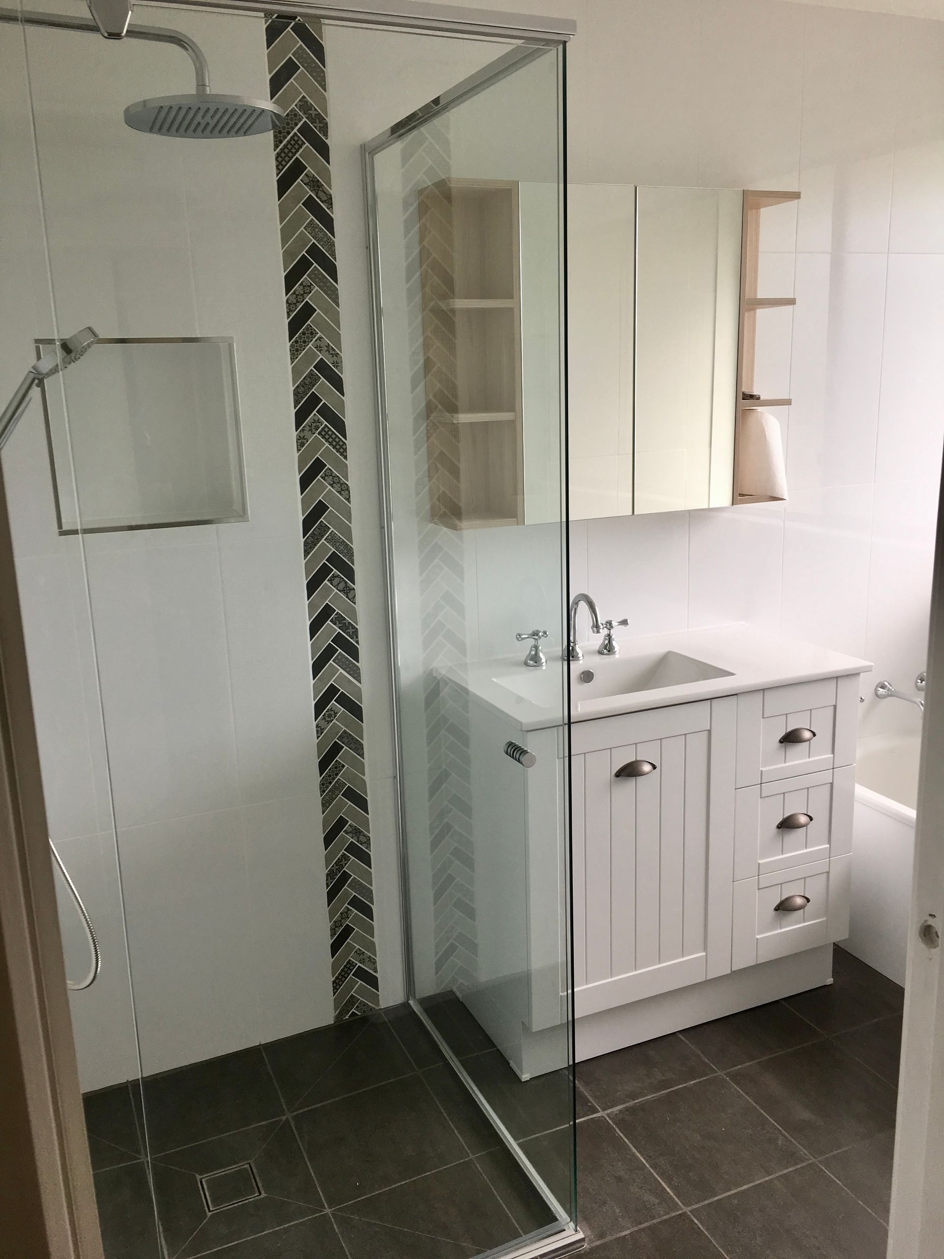 A Bathroom with Shower , Sink , Mirror and Bathtub — P & M Maintenance Building Services in Yass River, NSW