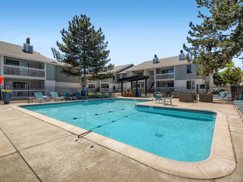 Preserve at City Center apartment community pool with lounge chairs and surrounding buildings.