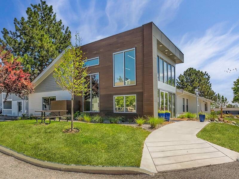 Exterior view of  Preserve at City Center with large windows, landscaping, and a curved walkway.