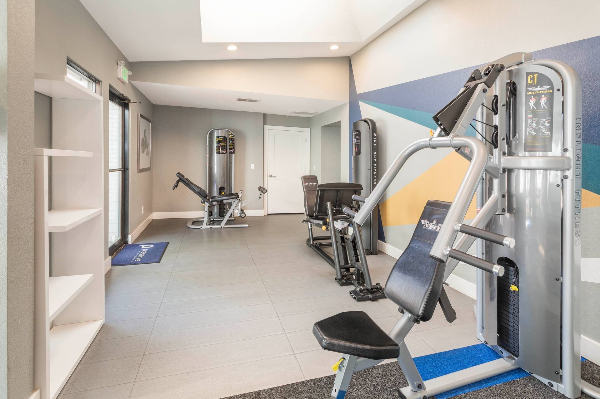 Interior view of Preserve at City Center apartment community gym with weight machines and benches.