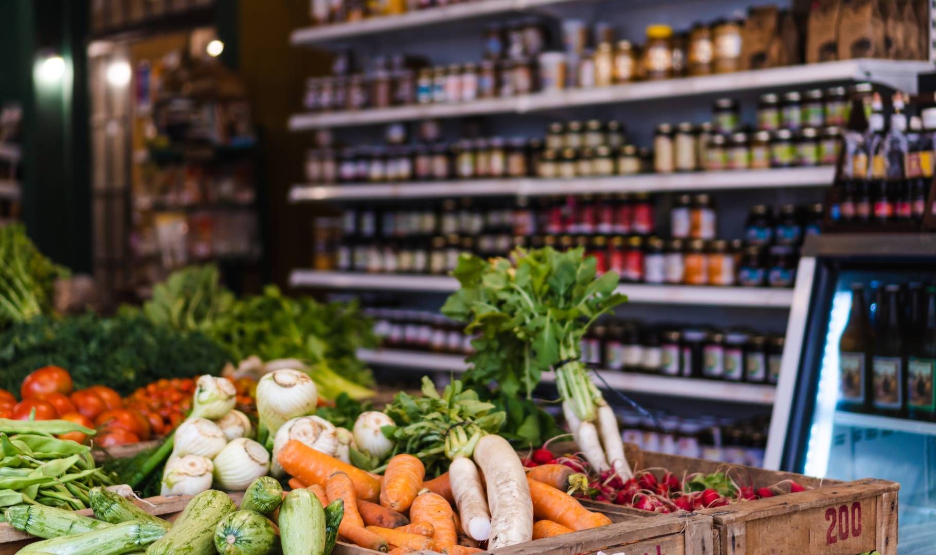 A variety of vegetables are on display in a grocery store.