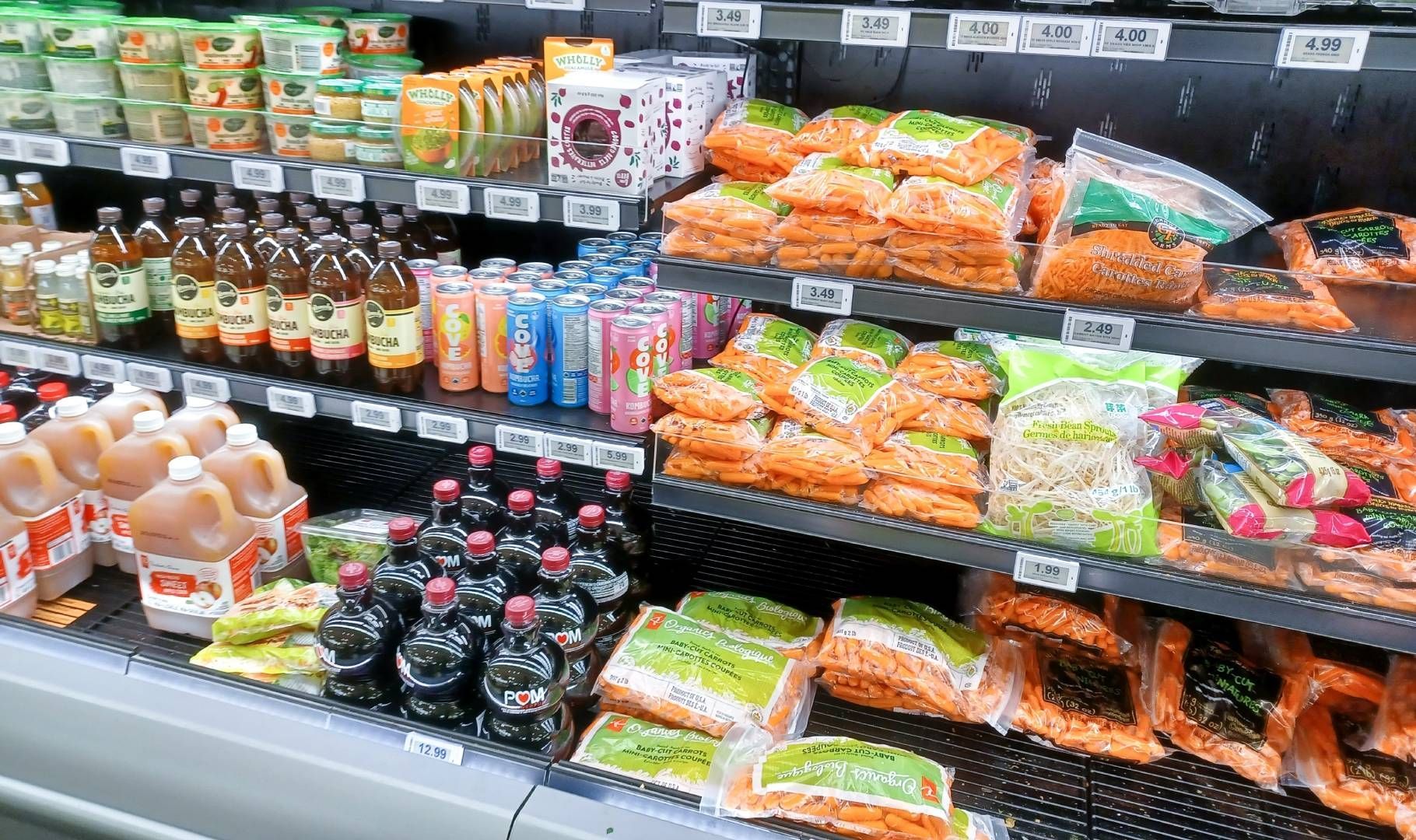 A grocery store aisle filled with lots of food and drinks.