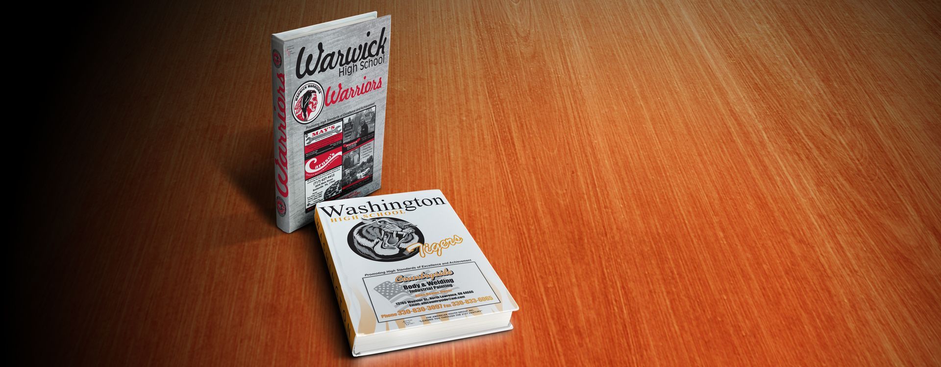 Two books on a wooden surface. One is standing, the other lying flat.