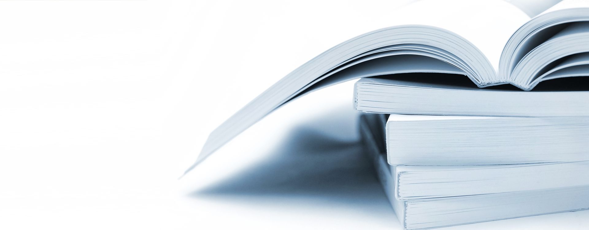 Stack of open books in blue and white.