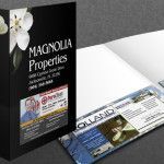 A black Magnolia Properties presentation folder with a white magnolia flower and business card.
