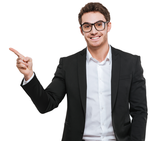 Man in suit and glasses points to the left, smiling.