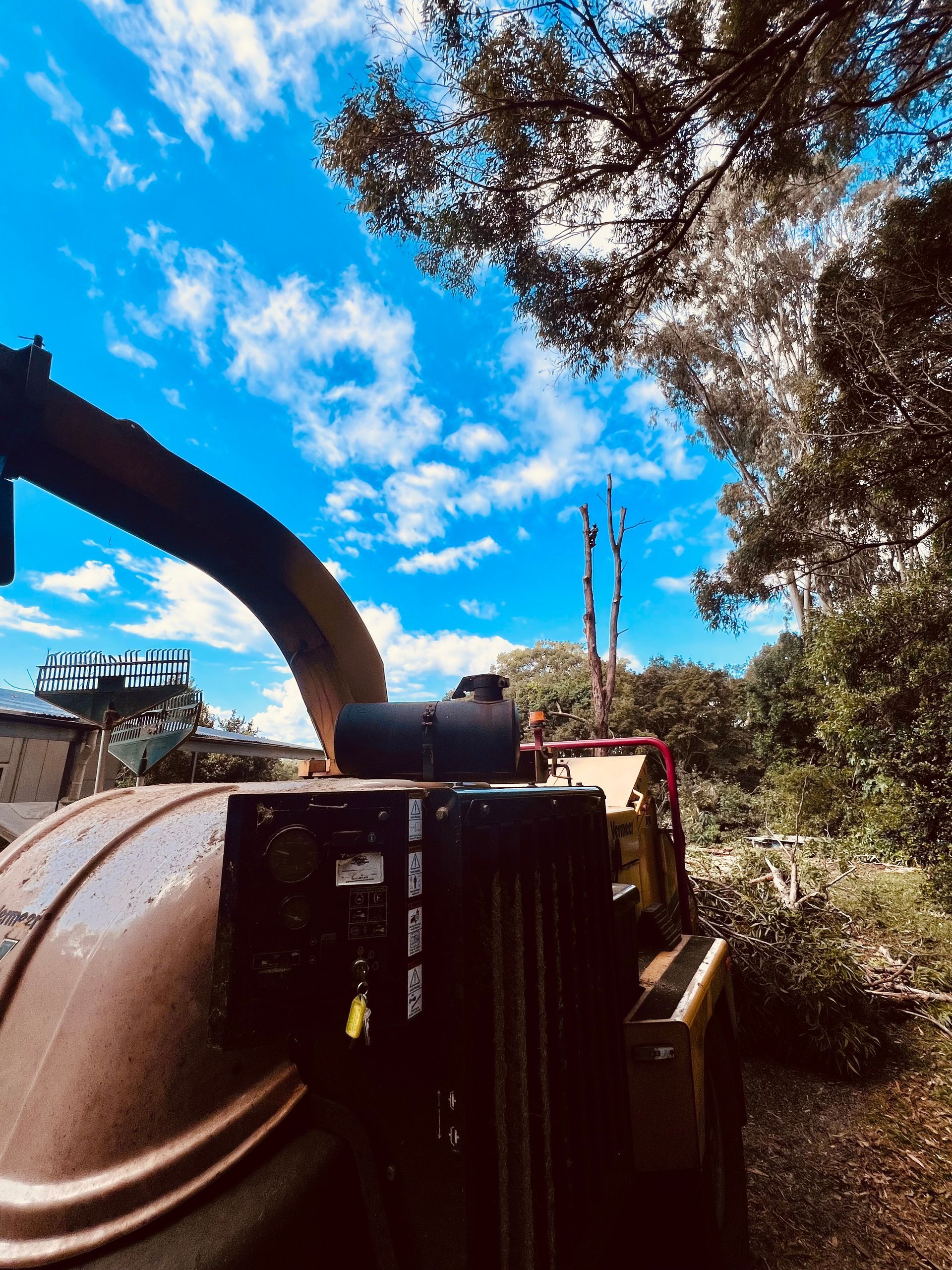 Wood Chipper Against a Bright Blue Sky With White Clouds — AAA Trees On Tweed In Murwillumbah, NSW