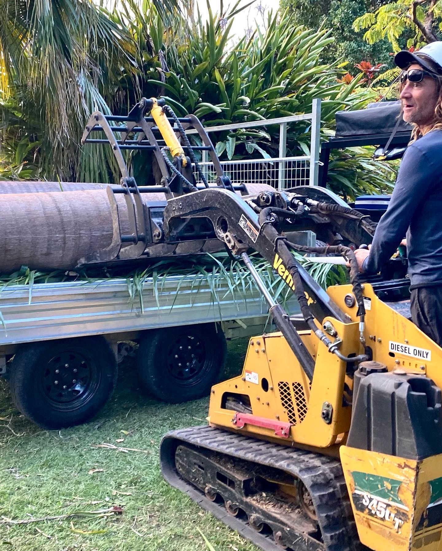 Man Operating a Yellow Mini Loader — AAA Trees On Tweed in Lennox Head, NSW