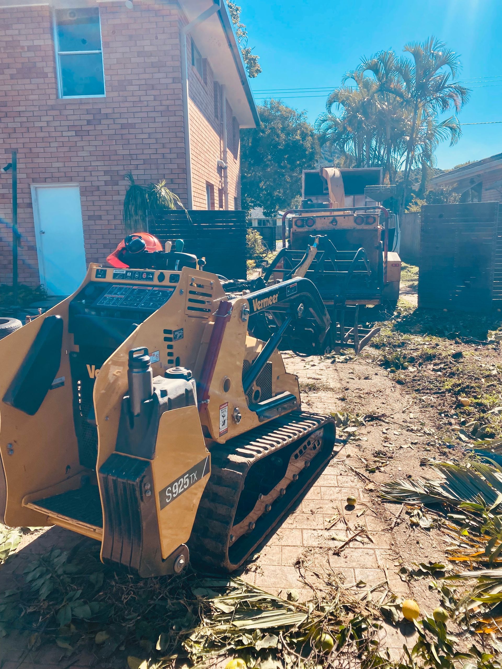 Yellow Mini-Excavator on Tracks in A Yard — AAA Trees On Tweed in Lismore, NSW