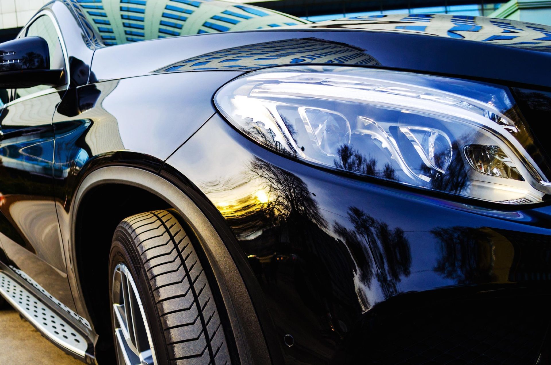 A close up of a car 's headlight and fender