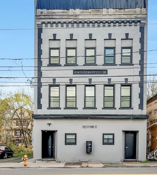 A tall building with a fire hydrant in front of it