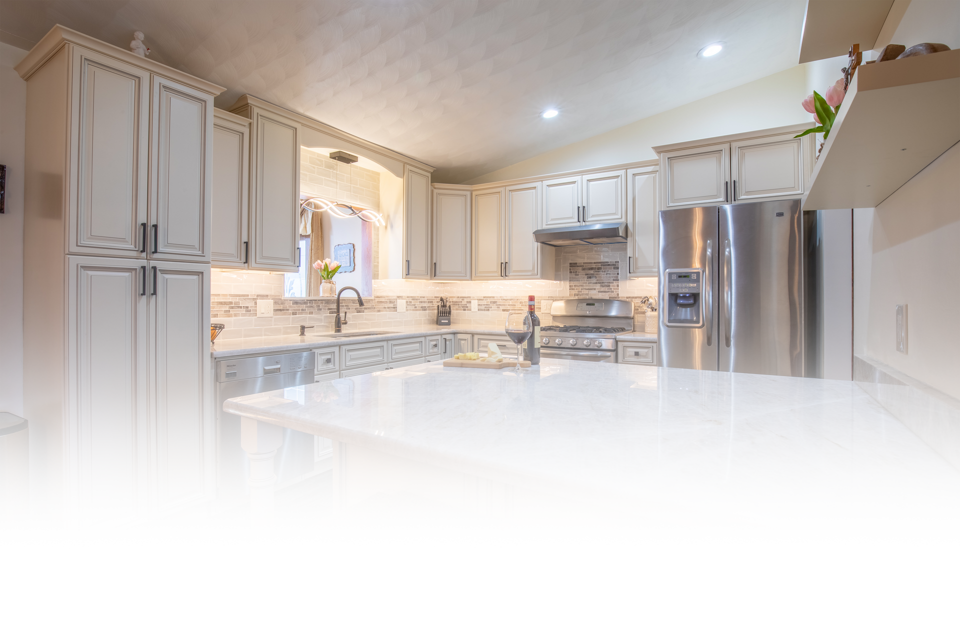 A kitchen with white cabinets and stainless steel appliances.