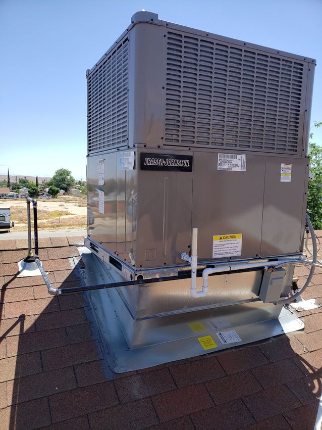 A large air conditioner is sitting on top of a roof