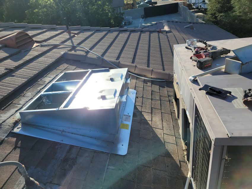 A roof with a metal item on top of it