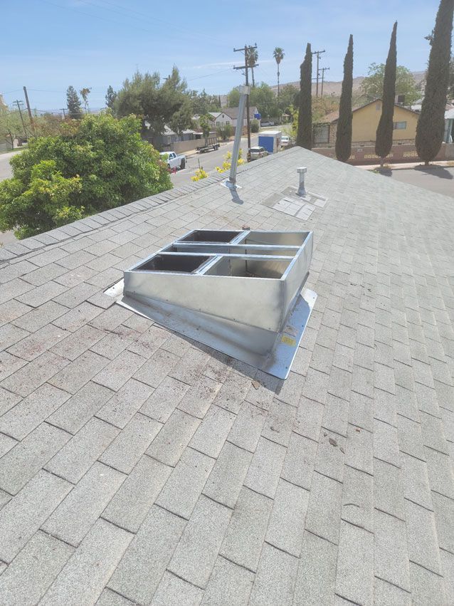 A roof with a skylight in the middle of it