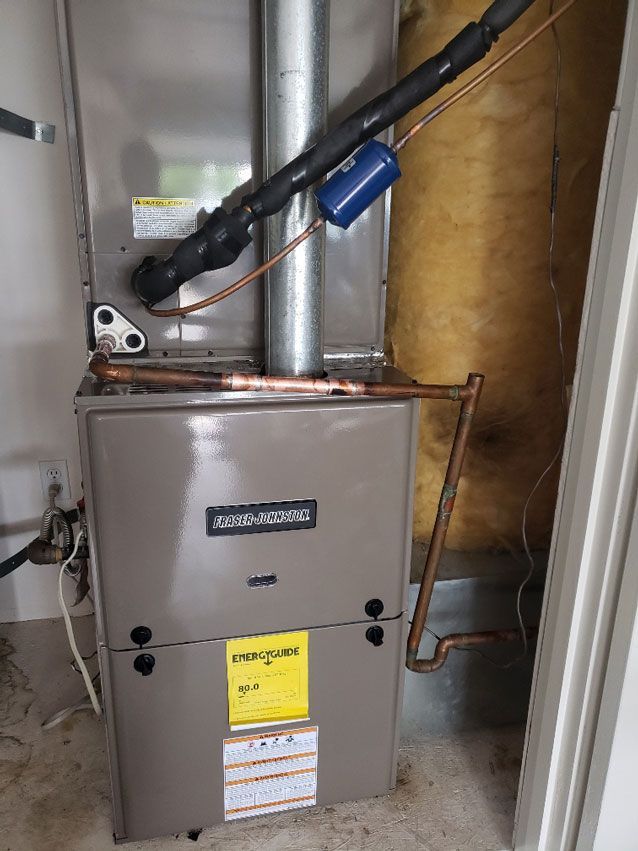 A furnace is sitting in a room next to a door.