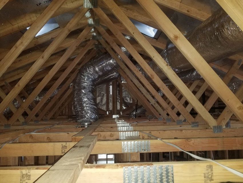 The ceiling of a house with a duct going through it