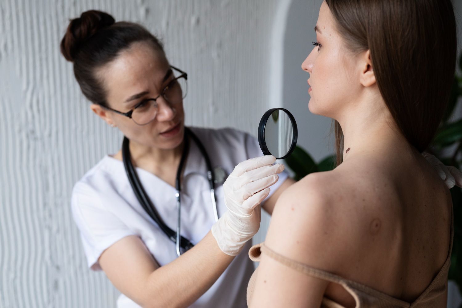 A doctor is examining a woman 's skin with a magnifying glass.