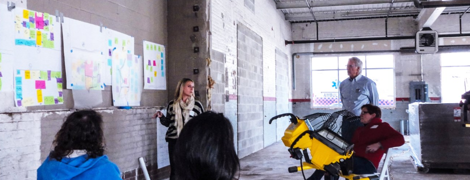 A group of people are sitting around a table in a room.