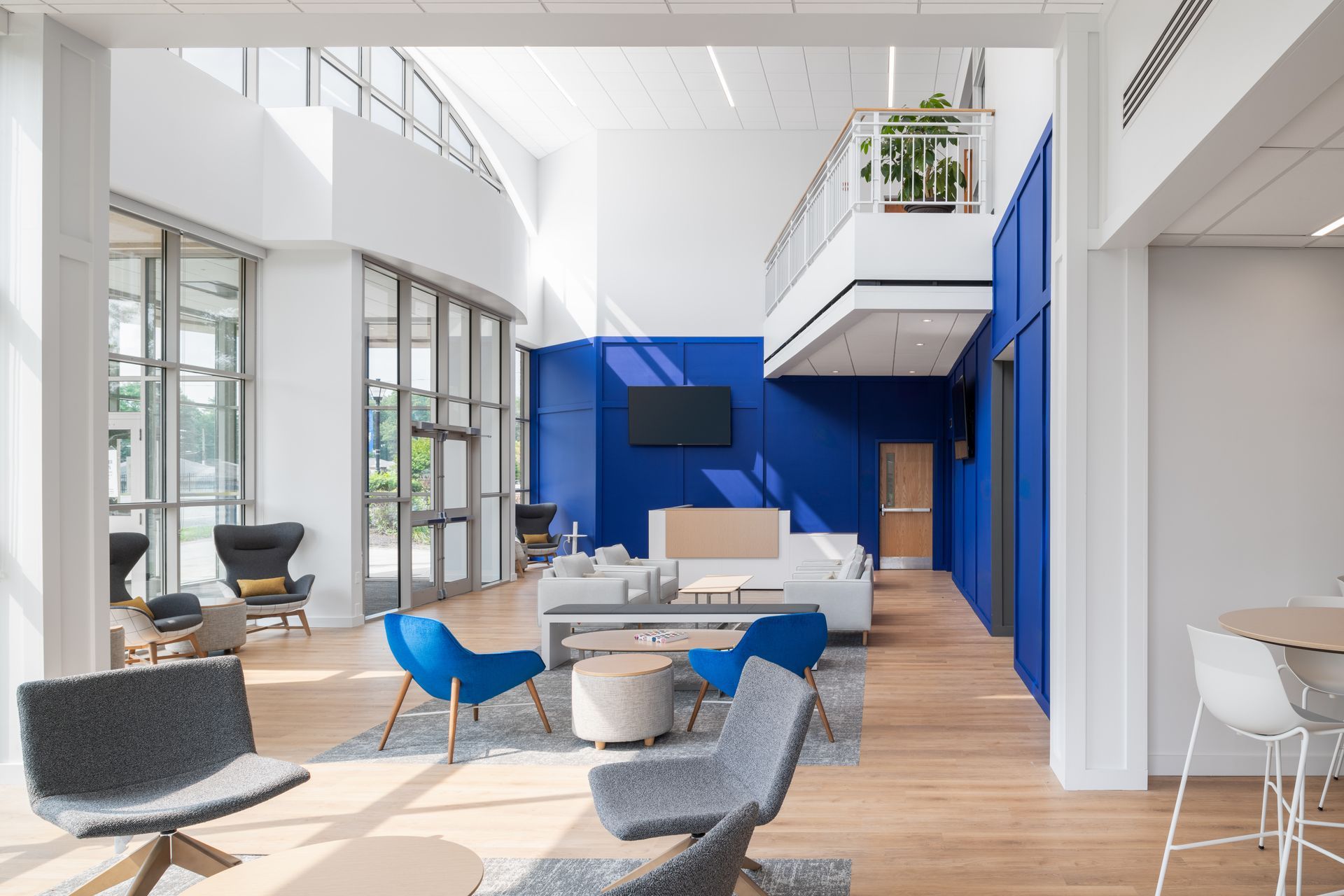 A living room filled with furniture and a blue wall.