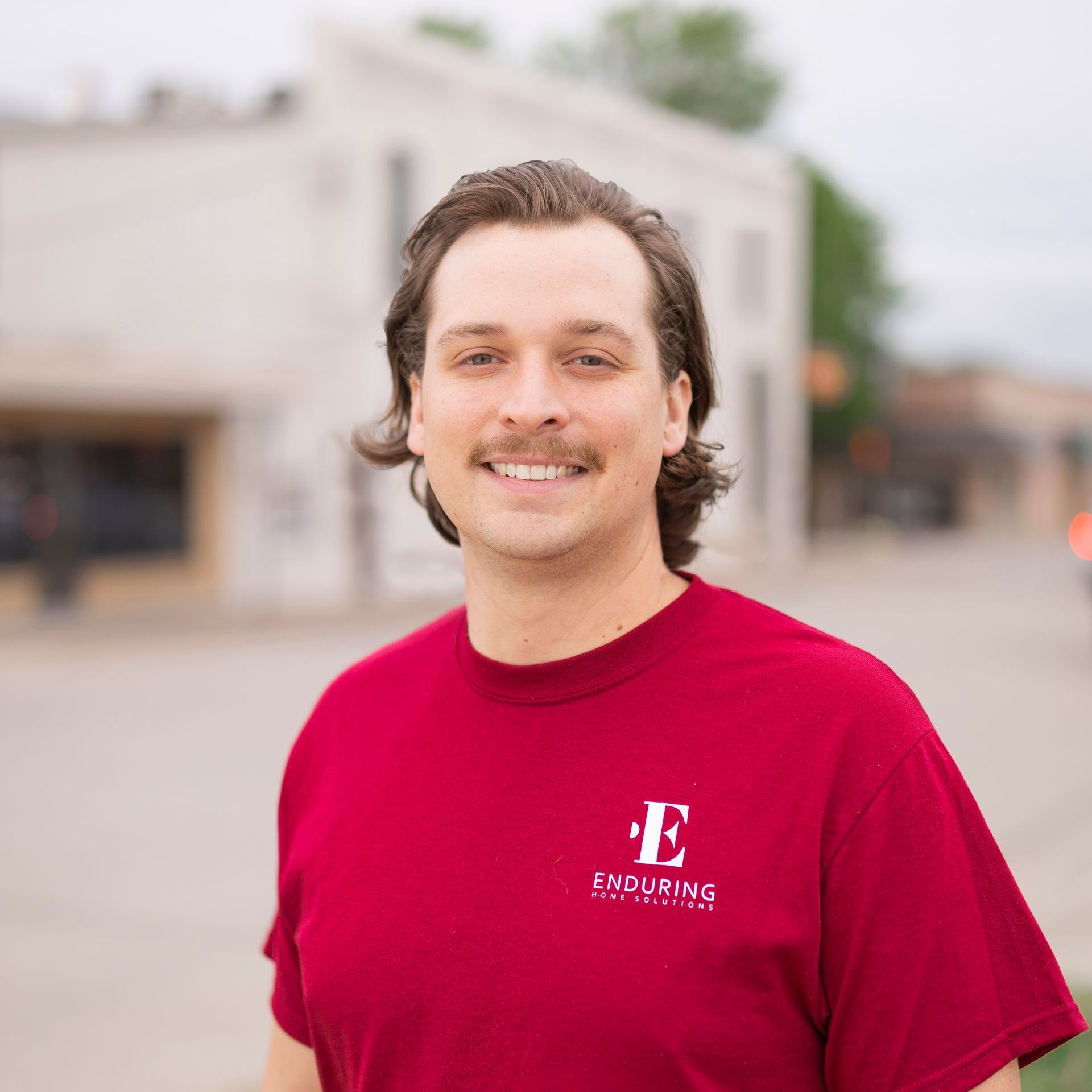 A man wearing a red shirt with the letter e on it