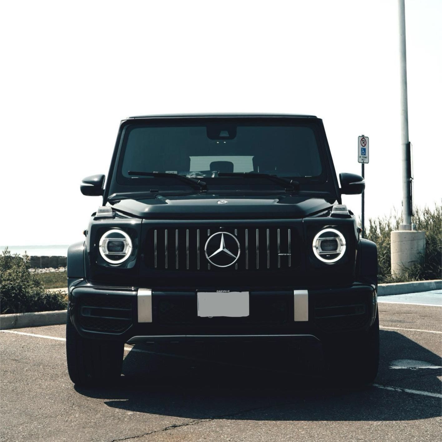 A black range rover is parked in front of a building.