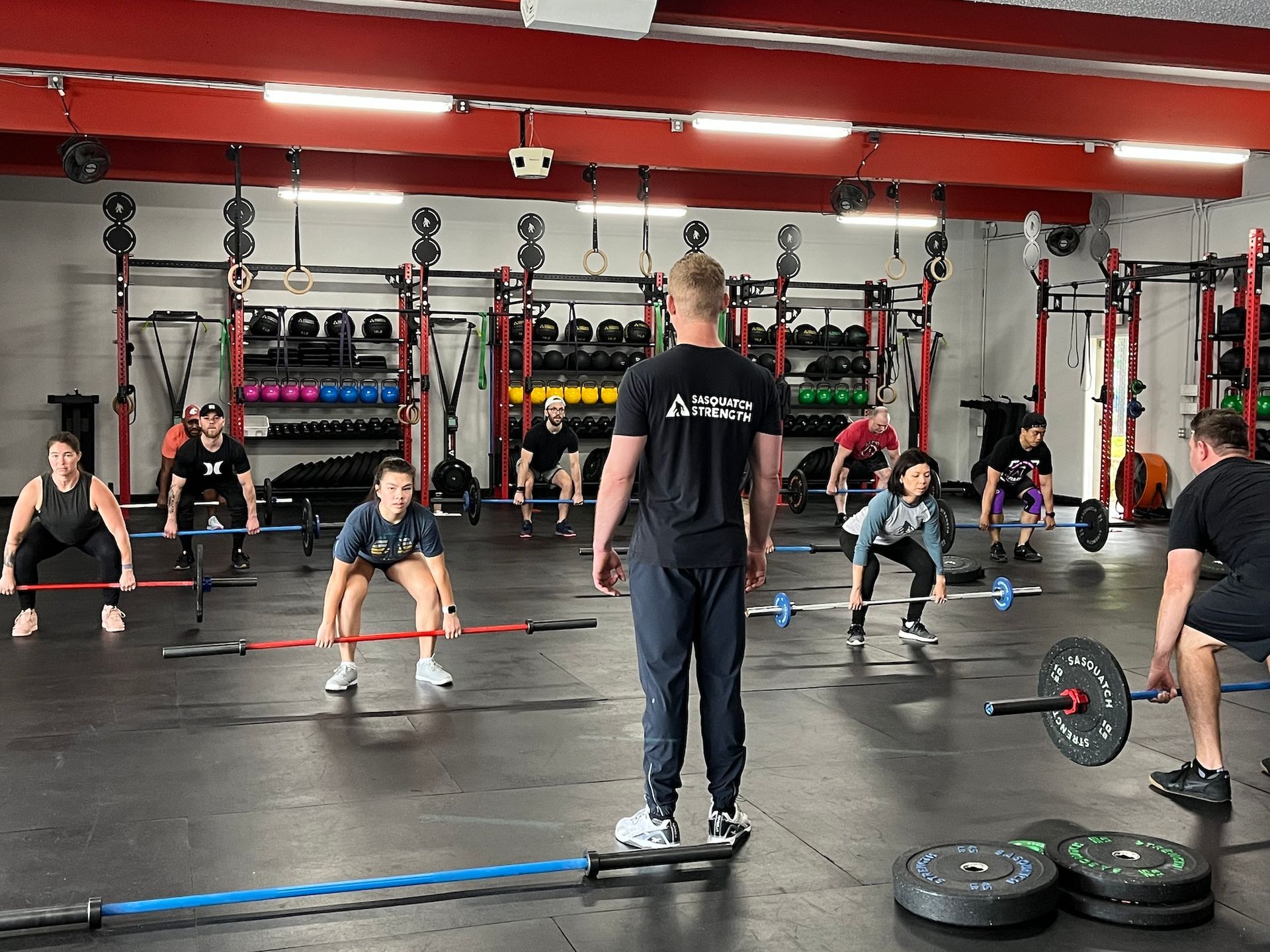 A man and a woman are standing next to each other in a gym. A man and a woman are standing next to each other in a gym.