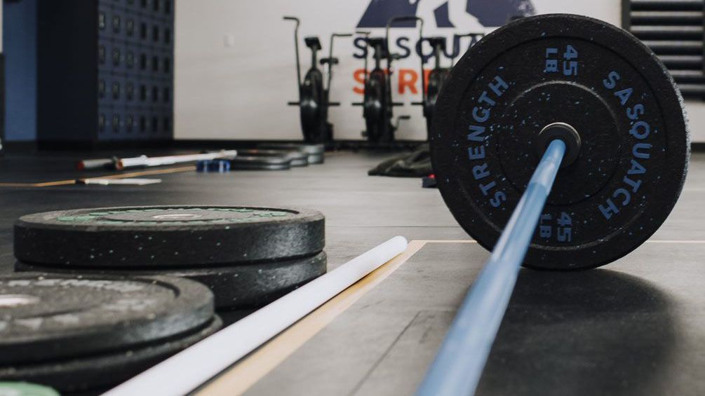 A barbell with the word strength on it