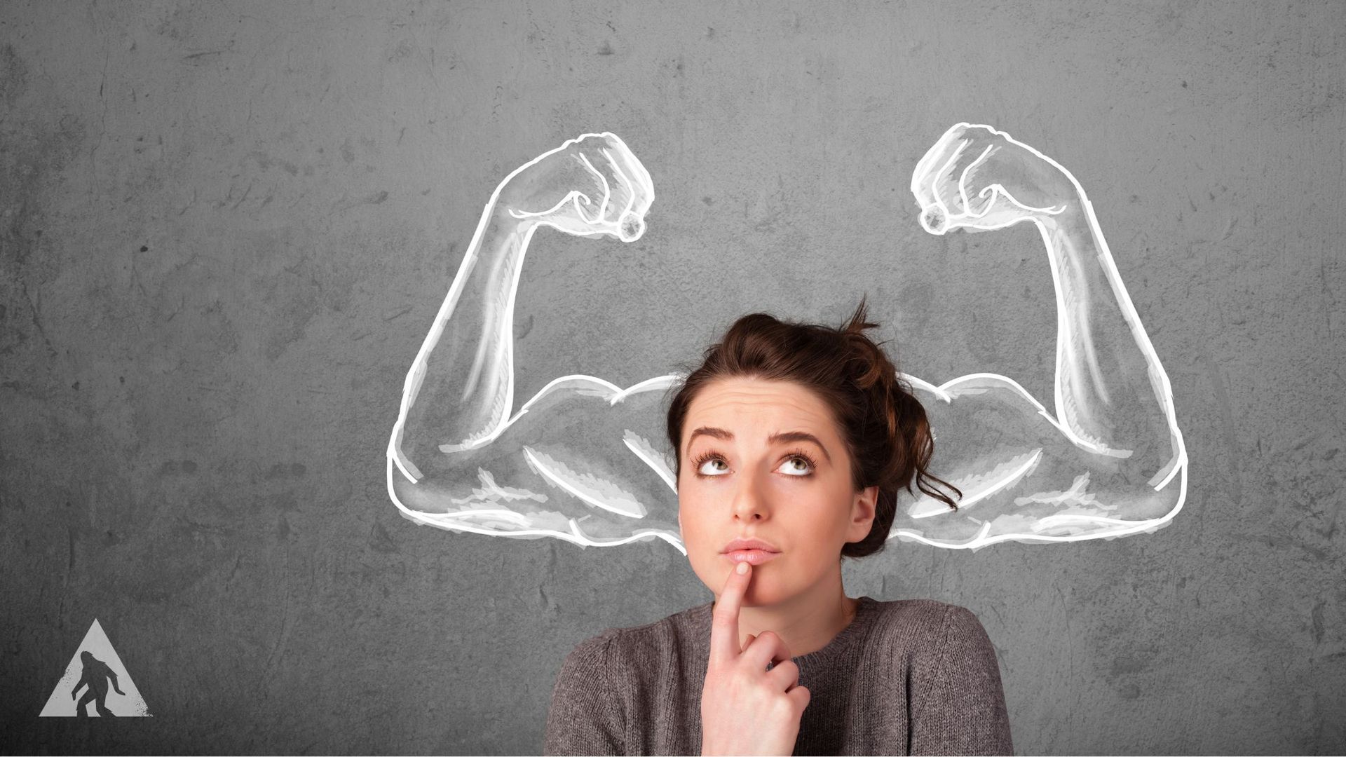 A woman is looking up at a drawing of muscles on a wall.