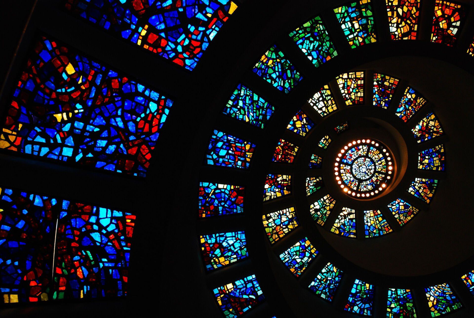 A spiral of stained glass windows in a church