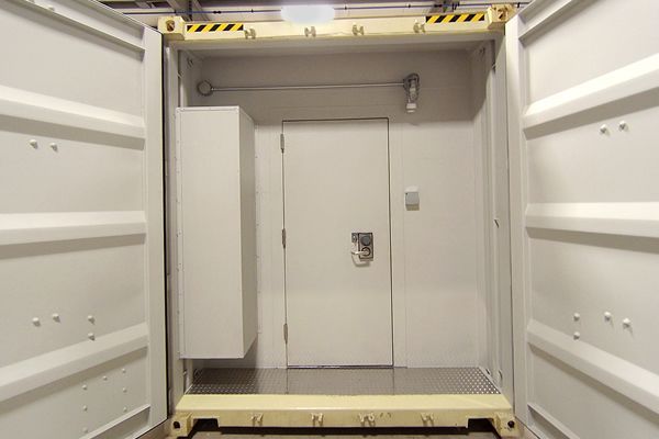 The inside of a shipping container with the door open.