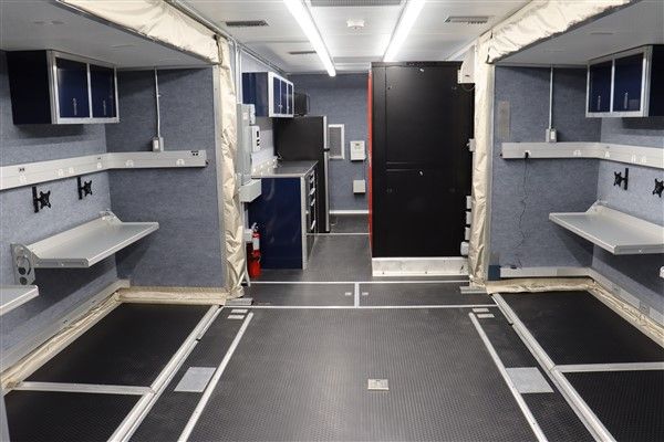 An empty room with a few shelves and a door