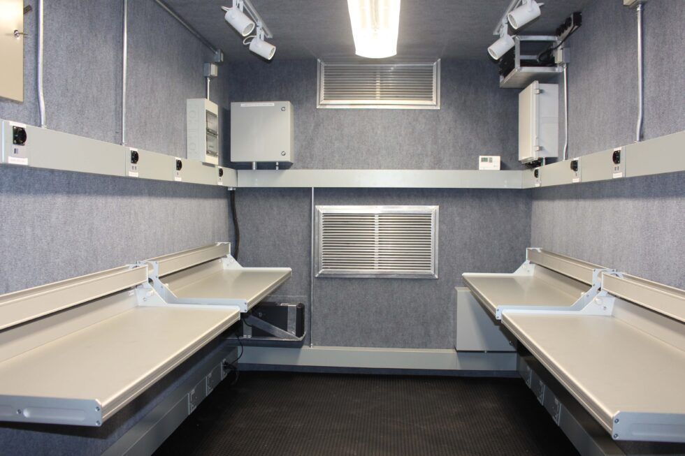 An empty room with two tables and a window
