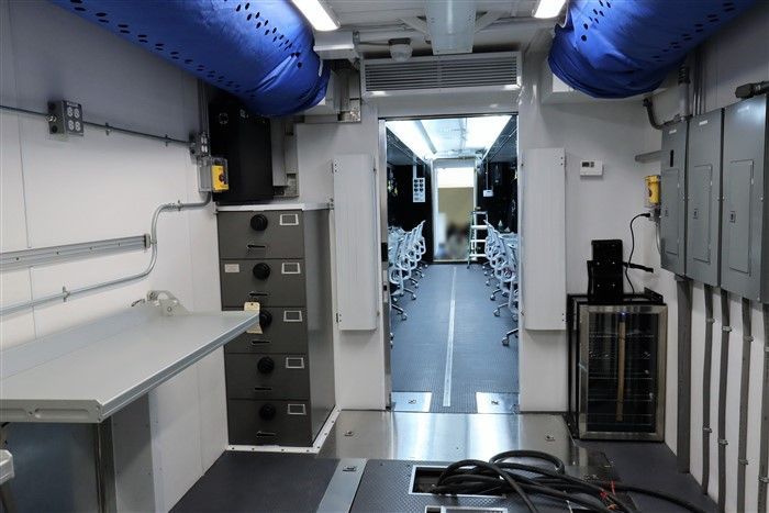A large room with a lot of wires hanging from the ceiling