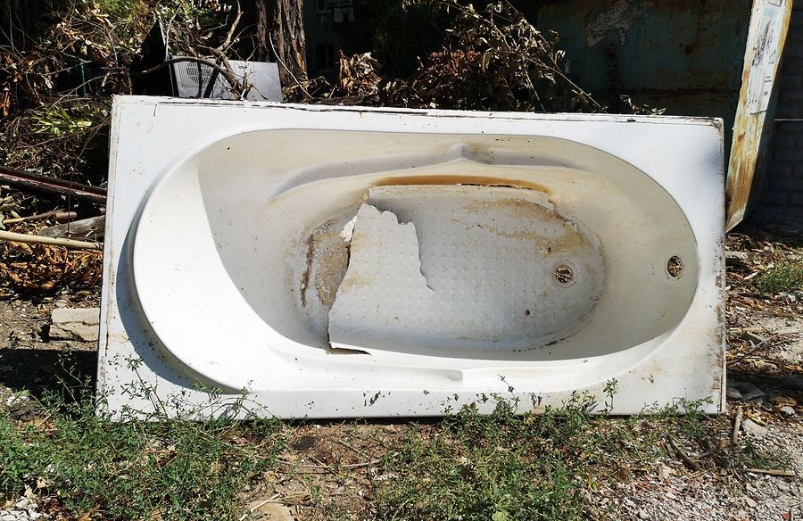 an old bath tub sitting in the grass