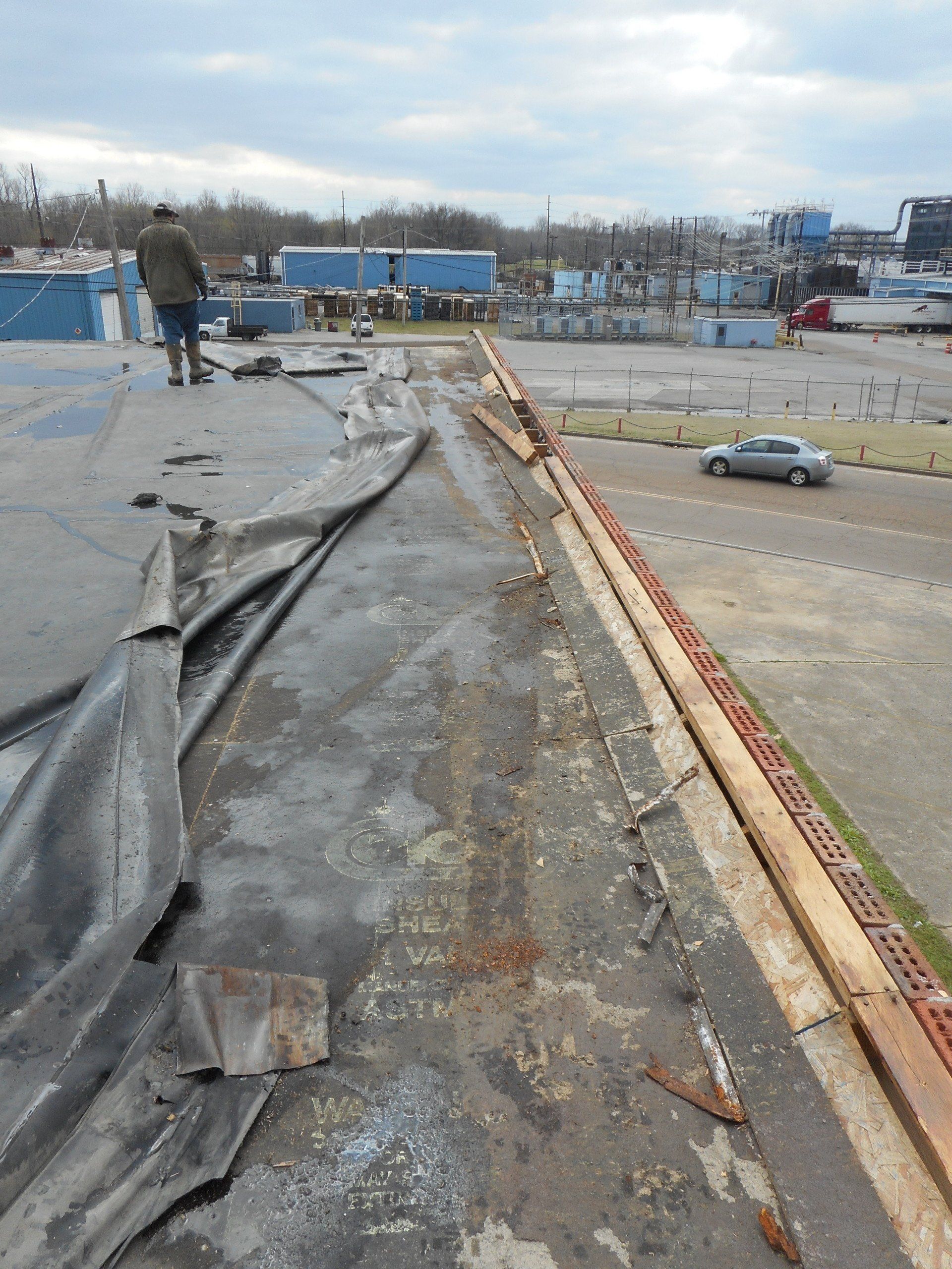 commercial roof damaged by high winds and storms