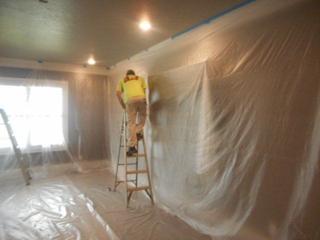 man preparing room for painting