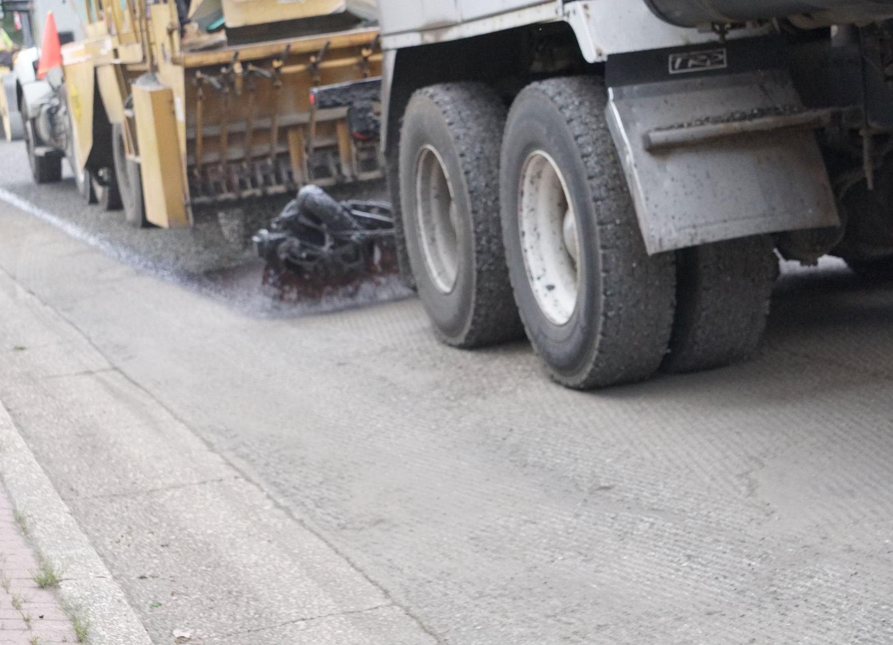 Closeup of emulsion spray followed by chip spreader