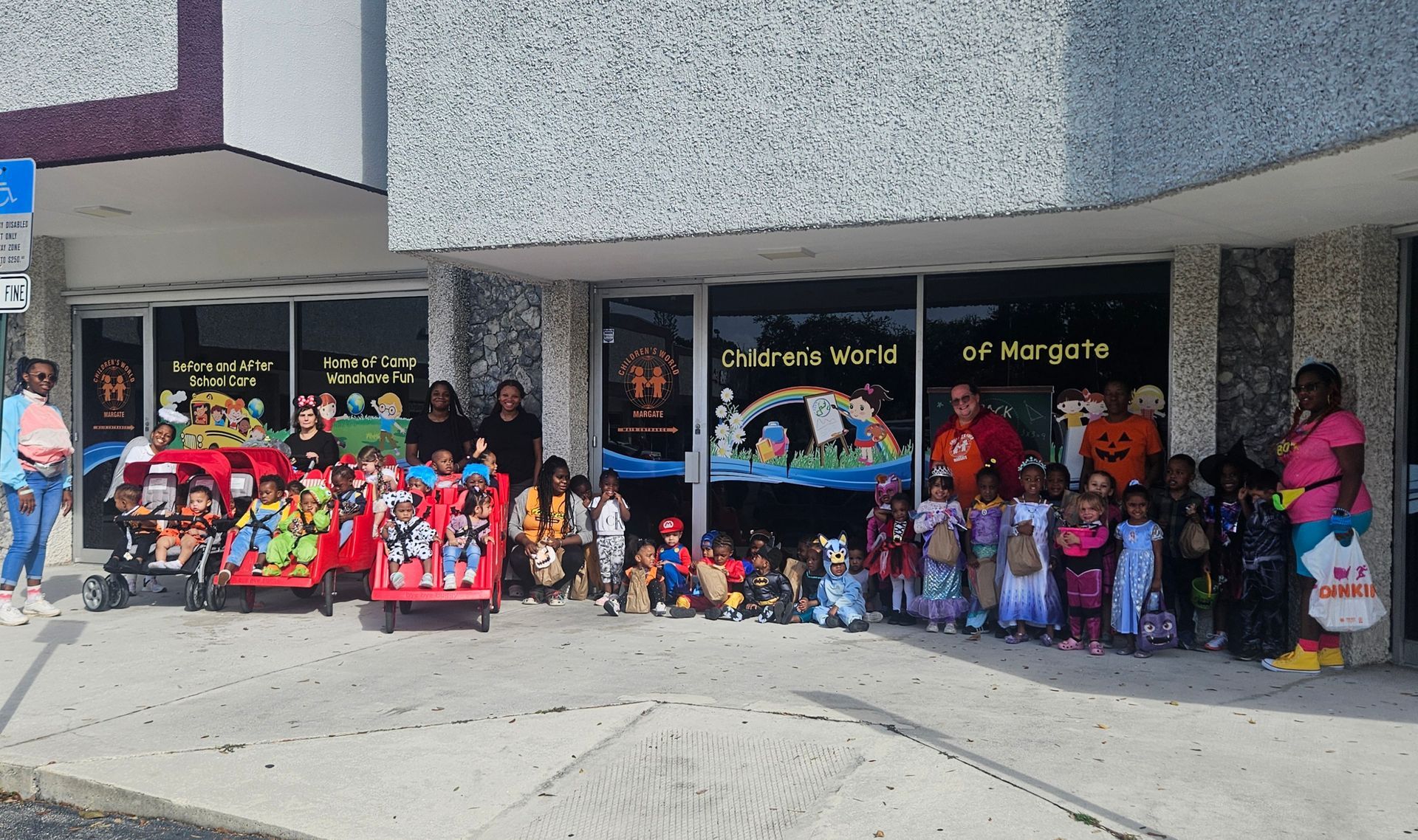 Children dressed in costumes outside Children's World of Margate; adults supervise.