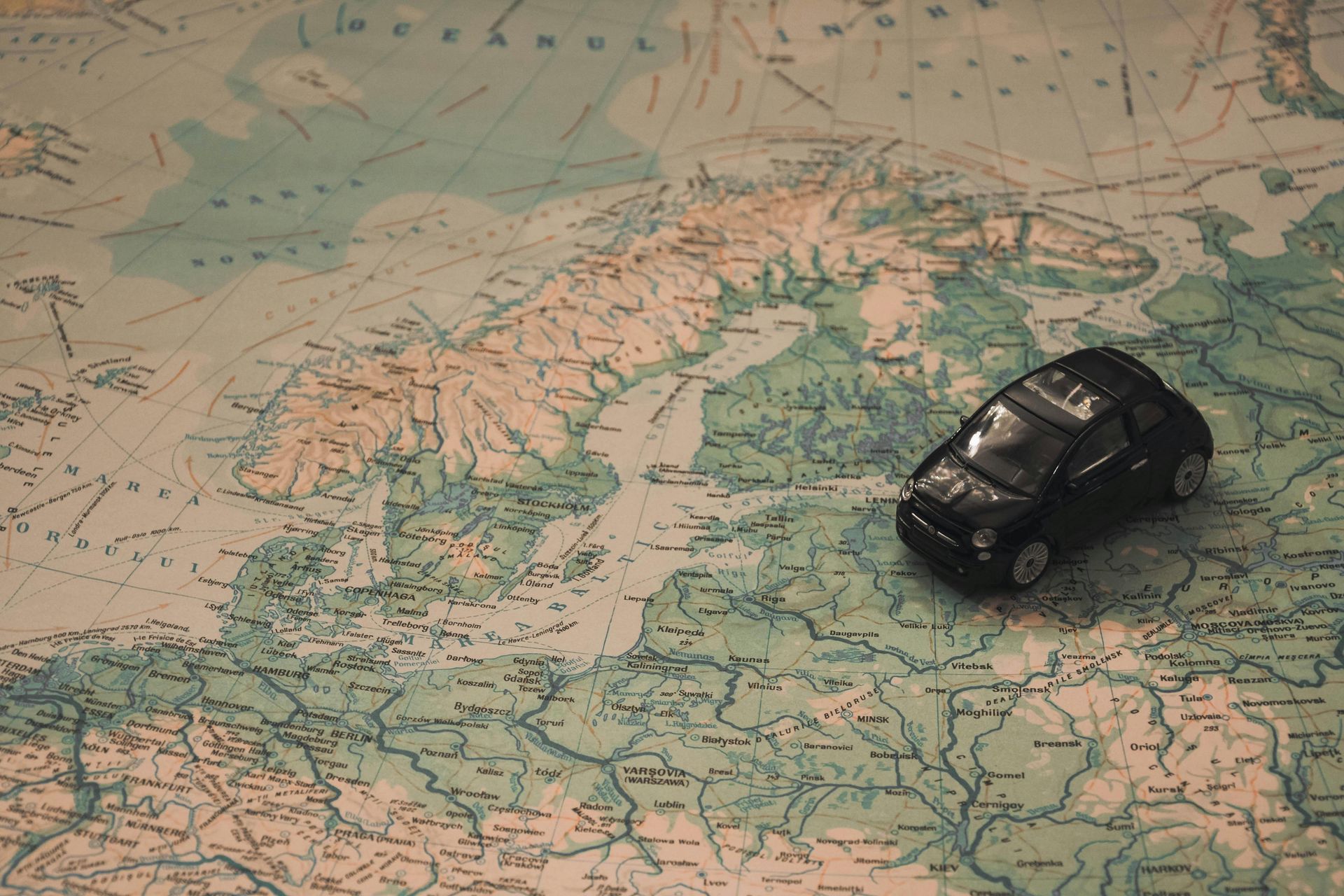 A toy car is sitting on top of a map.