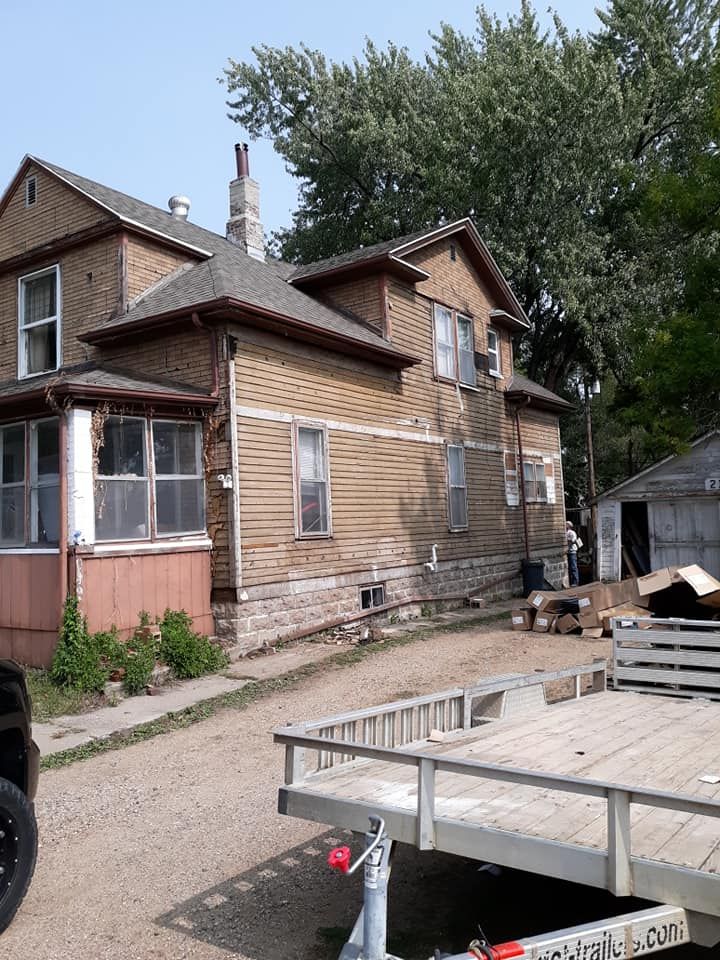 A house with a trailer parked in front of it