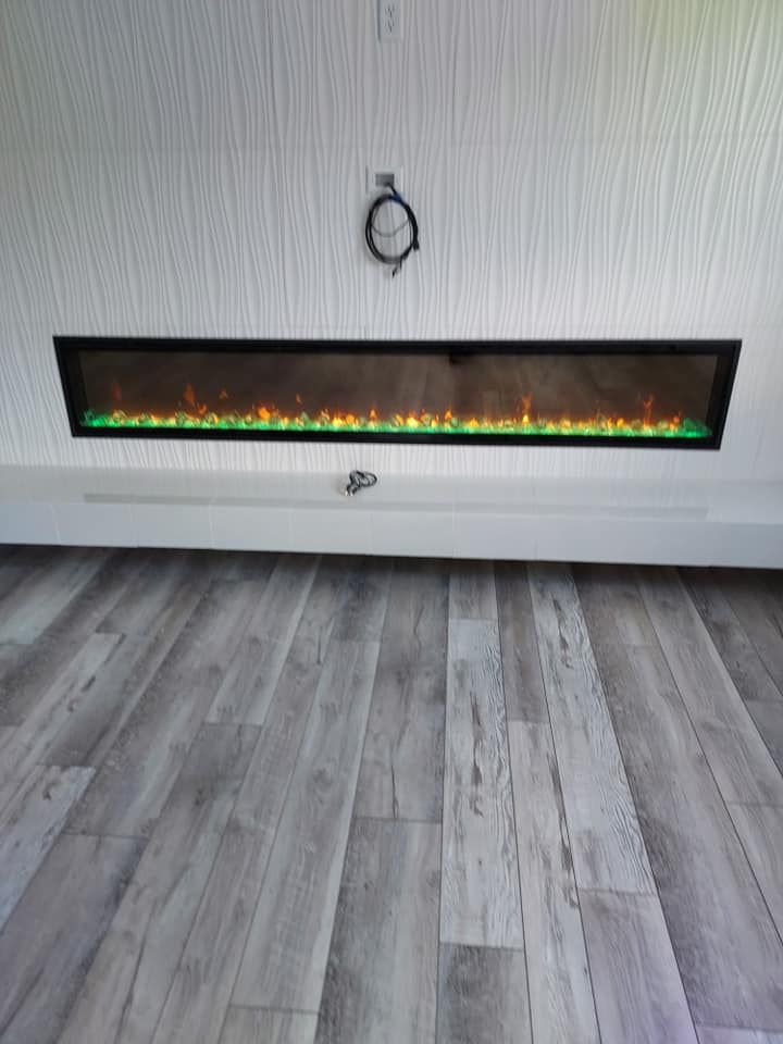 A living room with a fireplace and a wooden floor.