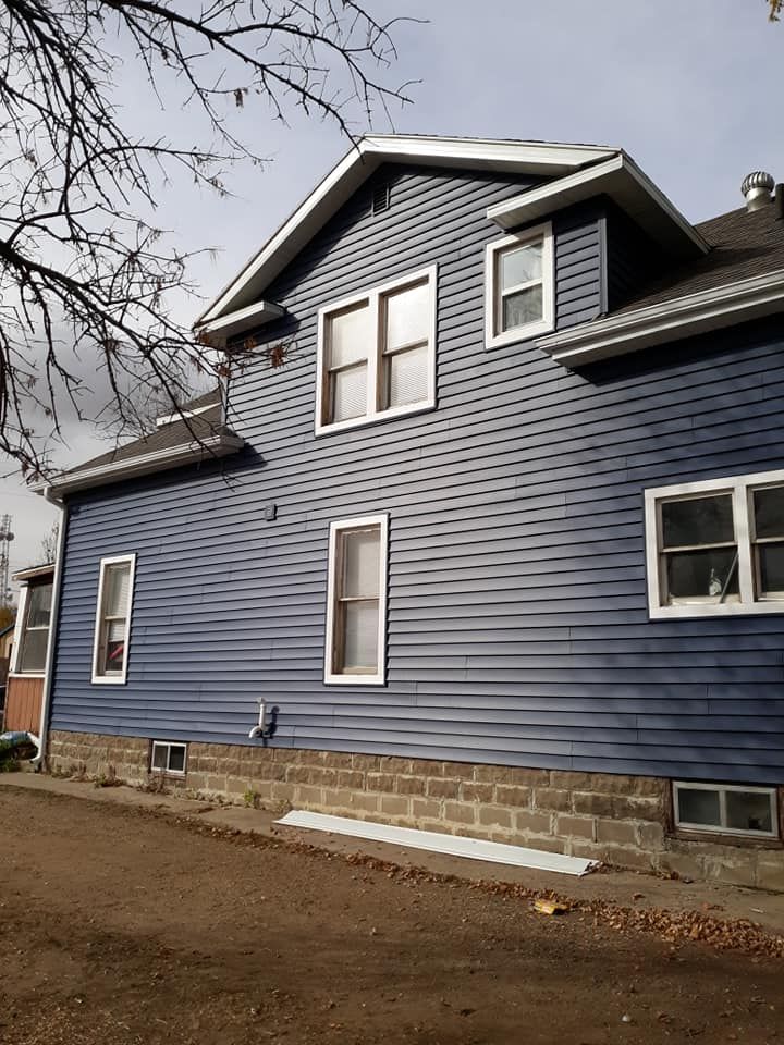 A large blue house with a lot of windows