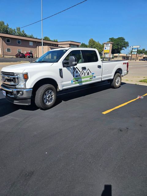 A white pickup truck is parked in a parking lot.