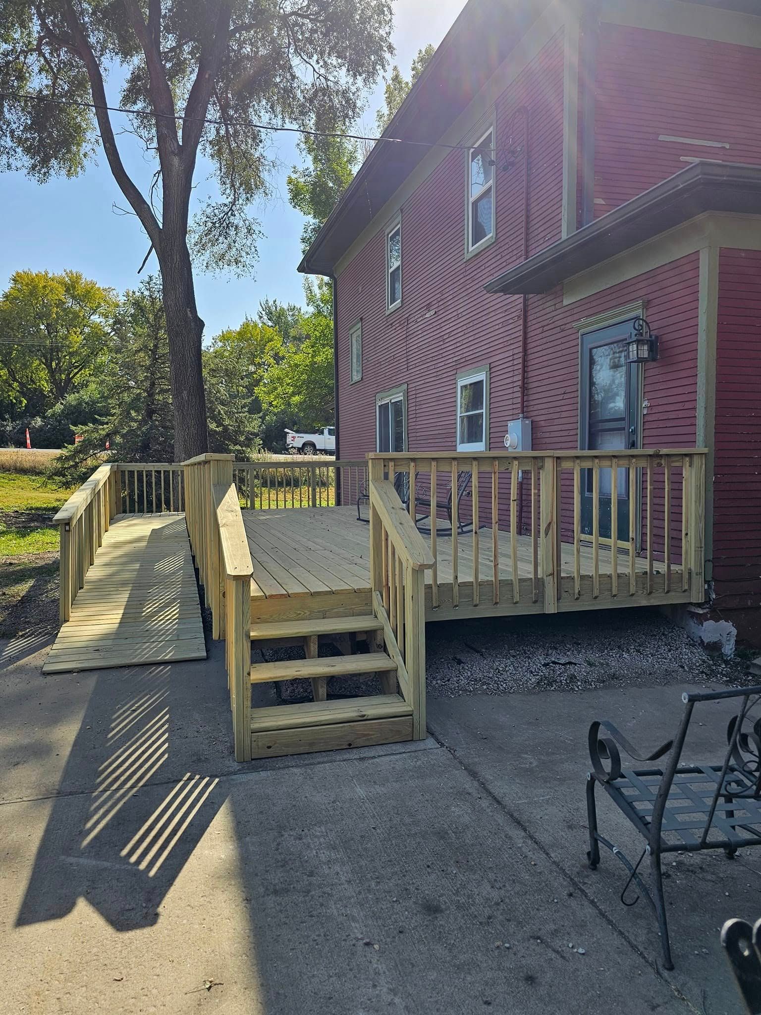 Wooden deck and ramp attached to a brick building.