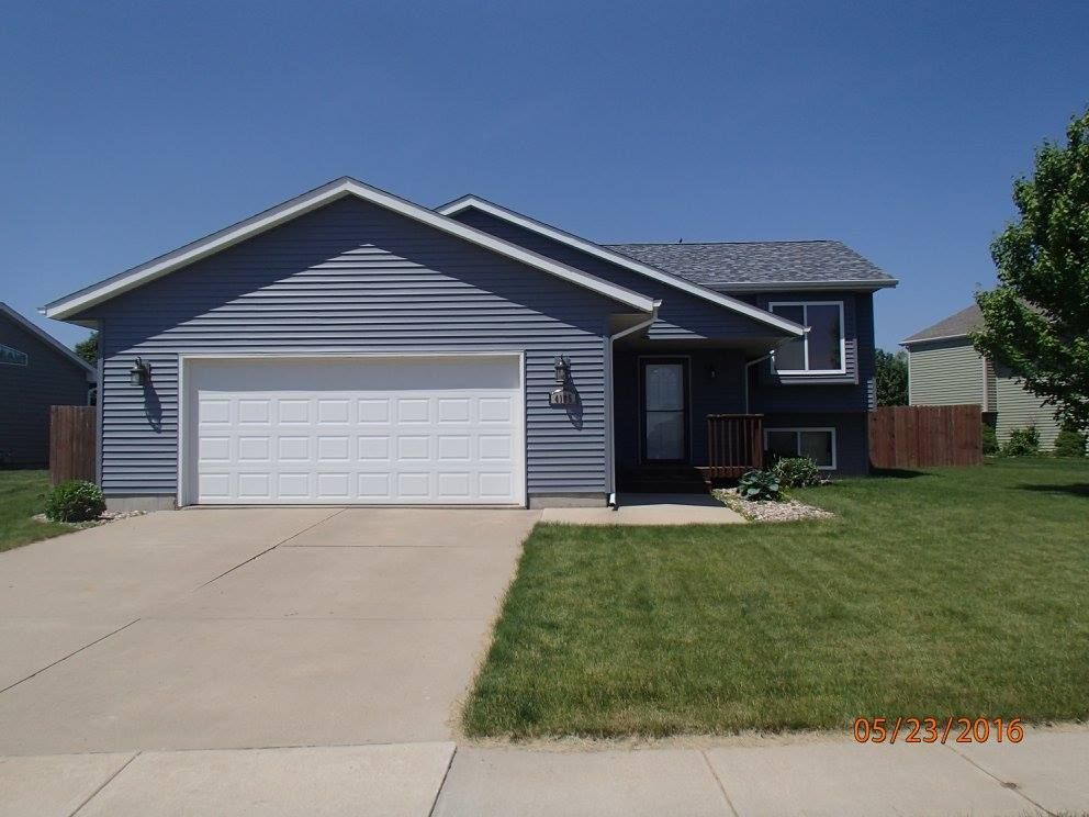 A blue house with a white garage door