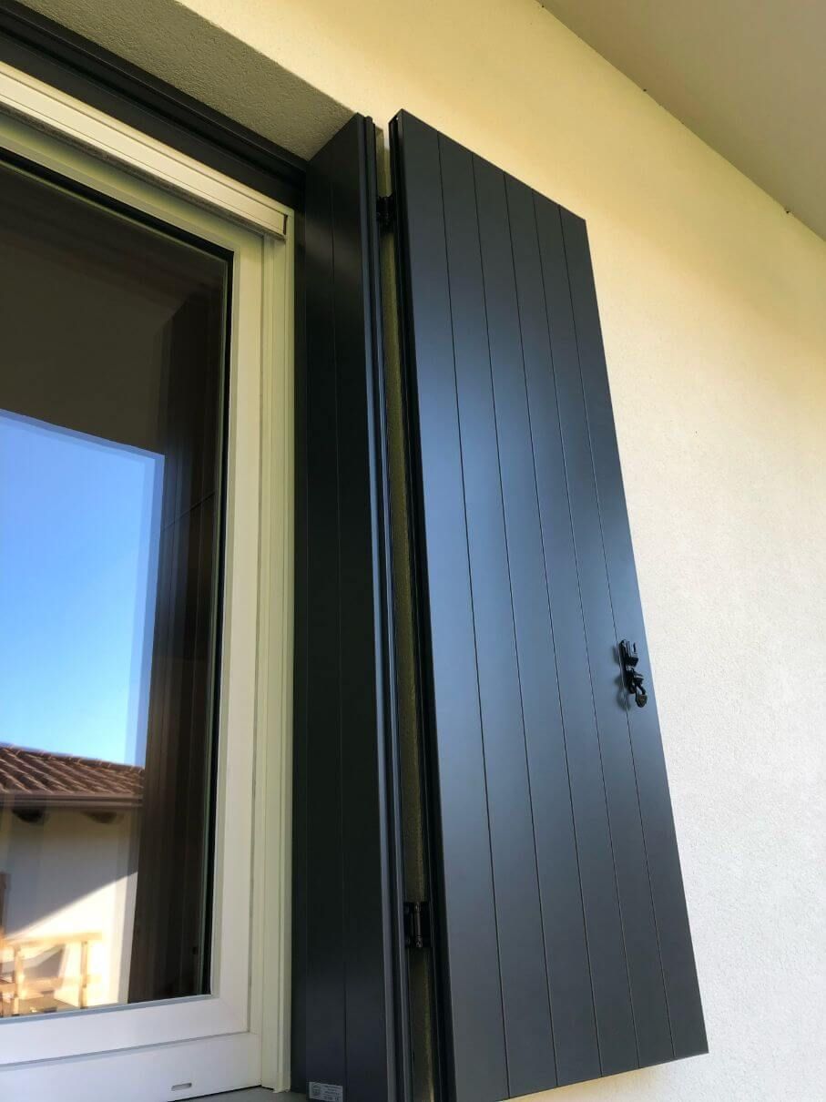 Una finestra con una persiana nera