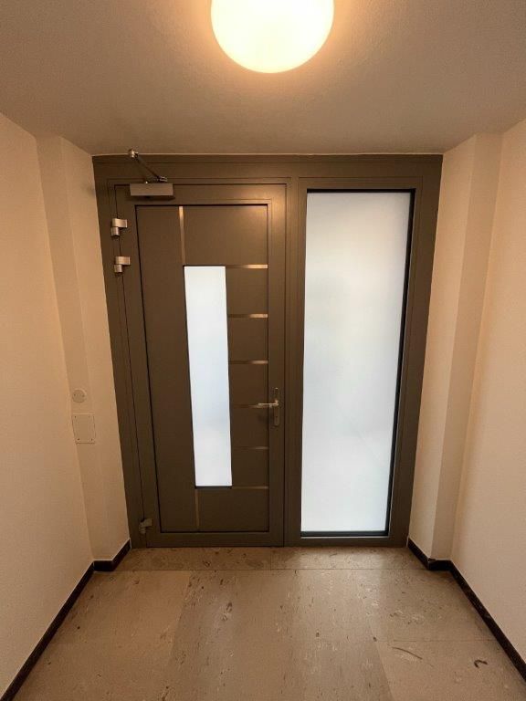 Un corridoio con una porta e una luce sul soffitto