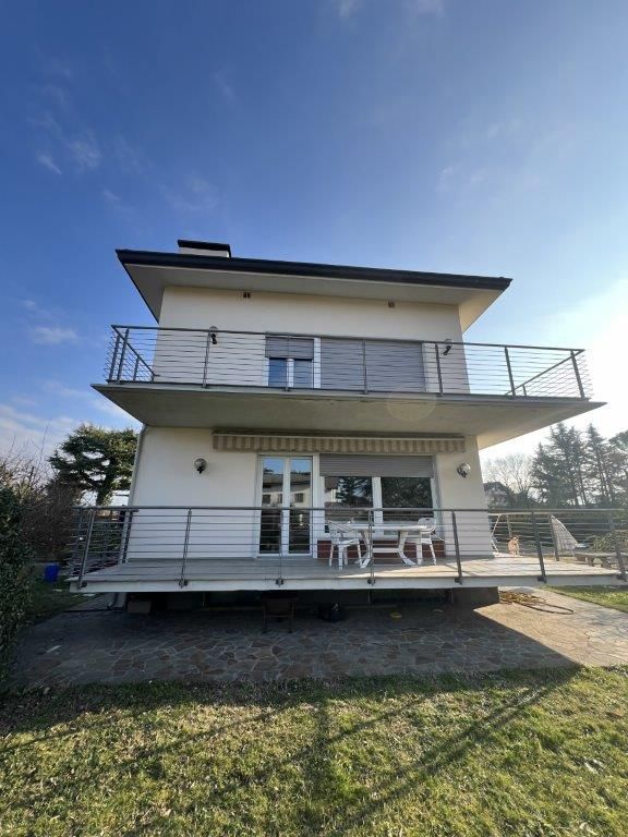 Una casa bianca con un balcone e un cielo azzurro sullo sfondo